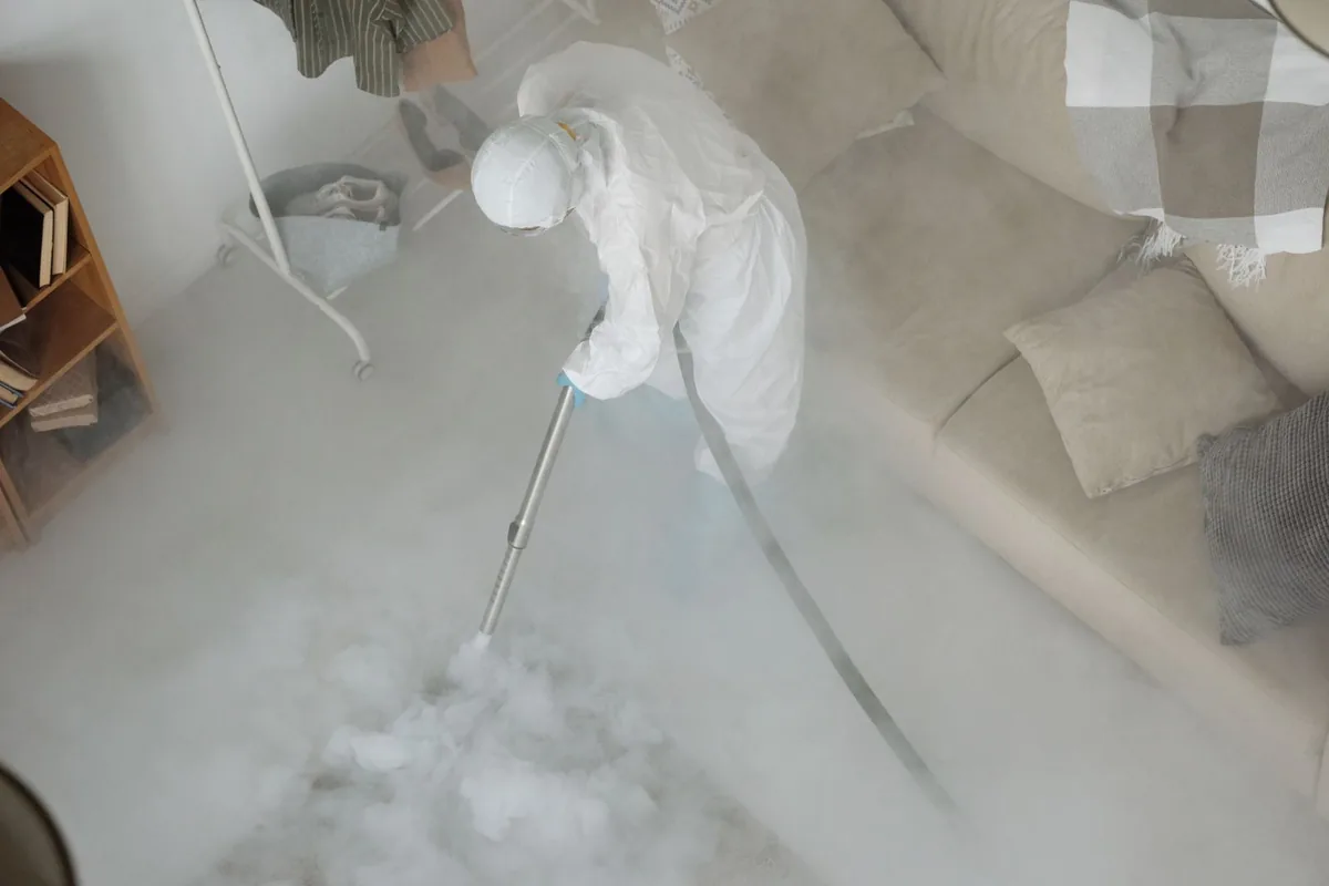 Biohazard cleanup technician in protective equipment, Anthony, NM